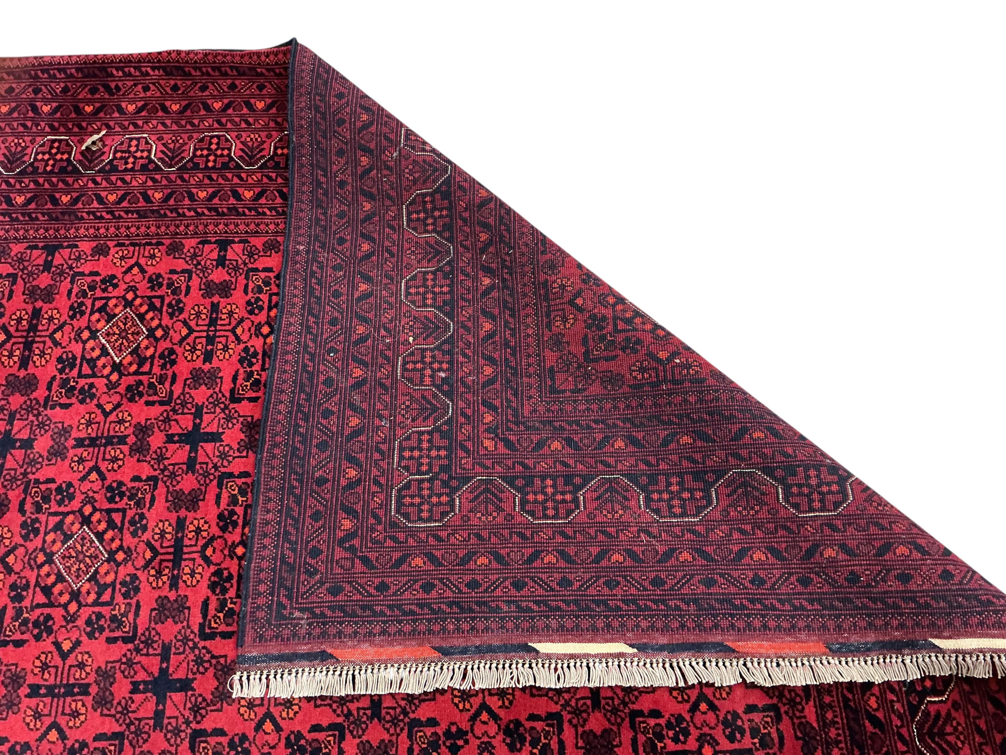 A Belouch red ground carpet, 240 x 170cm
